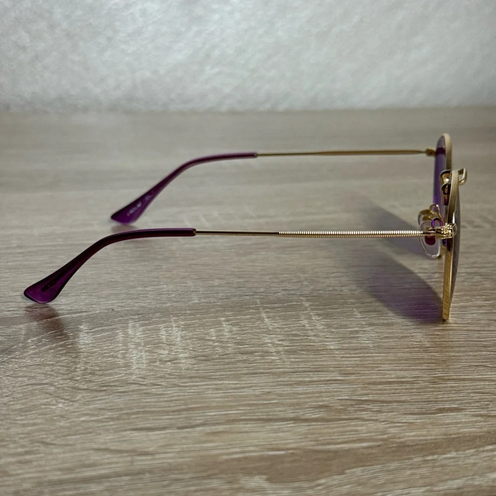 Rainbow OPTX Round sunglasses a gold metal frame and indigo purple lenses